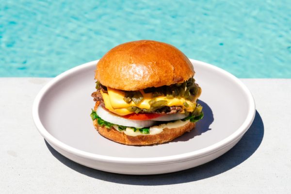 A Hatch green chile cheeseburger might be the best thing from New Mexico. Super juicy, slightly spicy, and oh so addictive. This is the burger recipe you want to be making right now. #burger #burgerrecipe #recipes #dinner #dinnerrecipes #cheeseburger #newmexico
